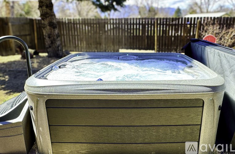 A hot tub is placed on a wooden deck.