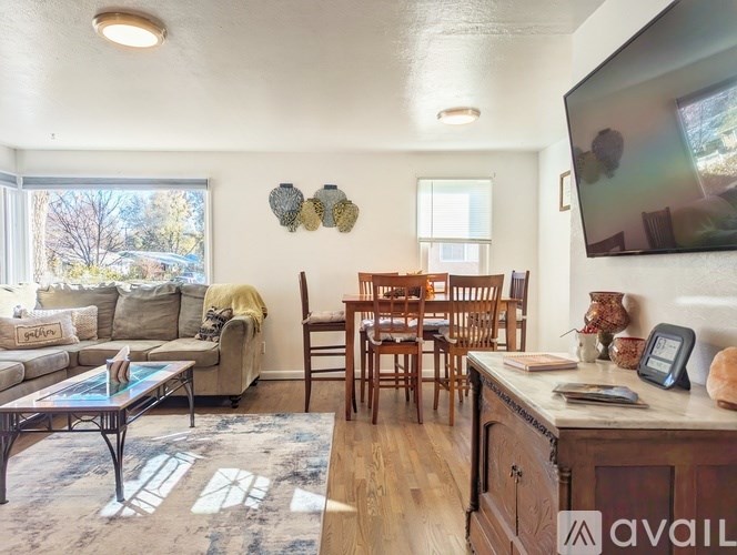 A living room with a couch, chairs, and a coffee table.