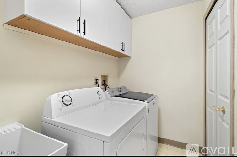 A white washing machine and dryer in a small laundry room.