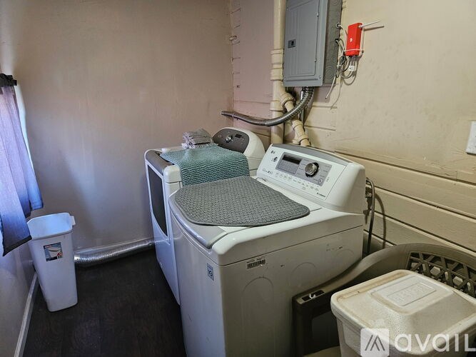 A washing machine and dryer in a small room.