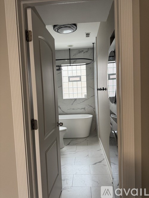 A bathroom with a tub, toilet and sink.
