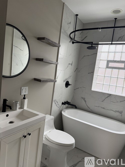 A bathroom with a white toilet, sink, and bathtub.