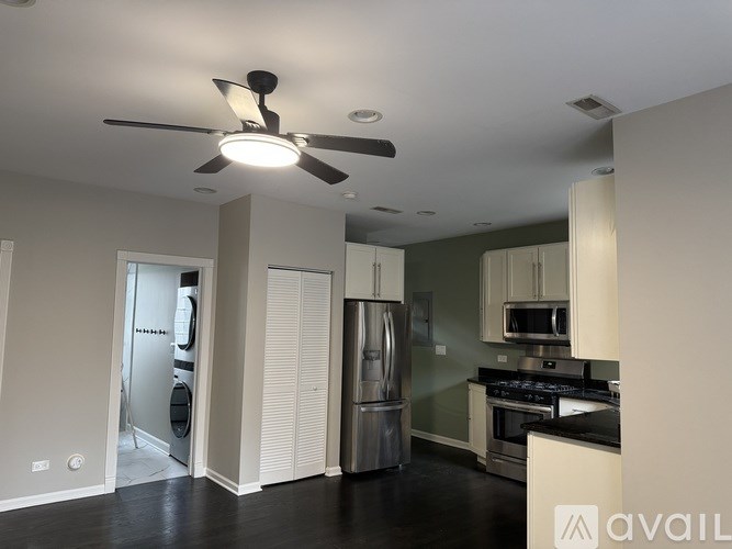 A kitchen with a refrigerator, oven, and microwave.