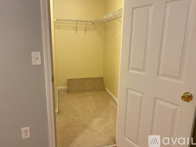 A small bedroom with a bed and a closet.