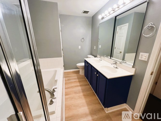 A bathroom with a white sink and a white toilet.
