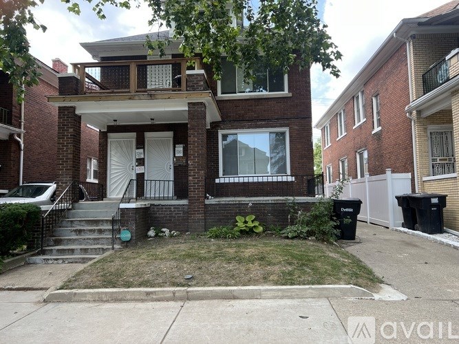 A brick house with a white door and a window.