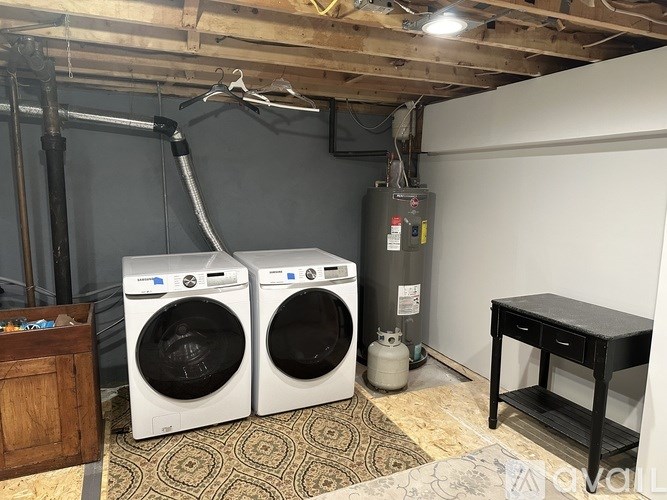 Two front loading washing machines in a laundry room.