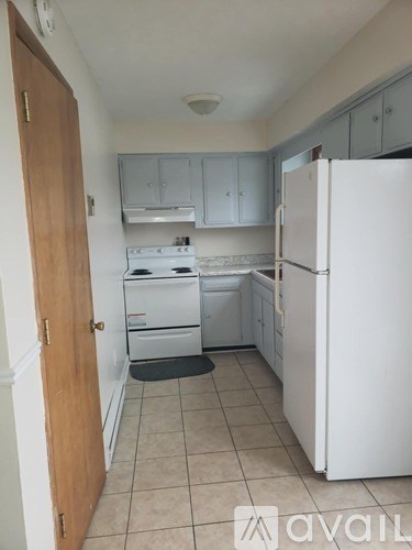 A kitchen with a white fridge and a white stove.