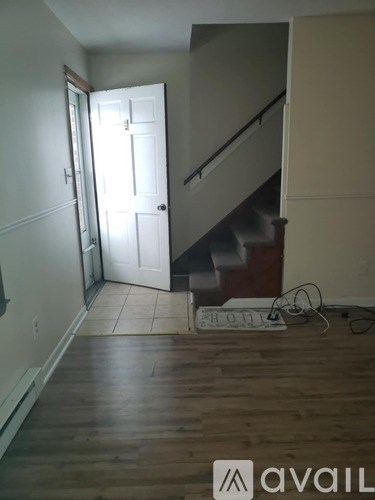 A room with a staircase and a door.