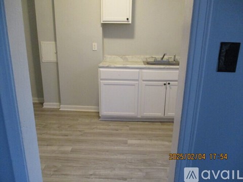 A bathroom with a sink and cabinets.