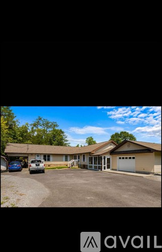 A building with a parking lot in front of it.