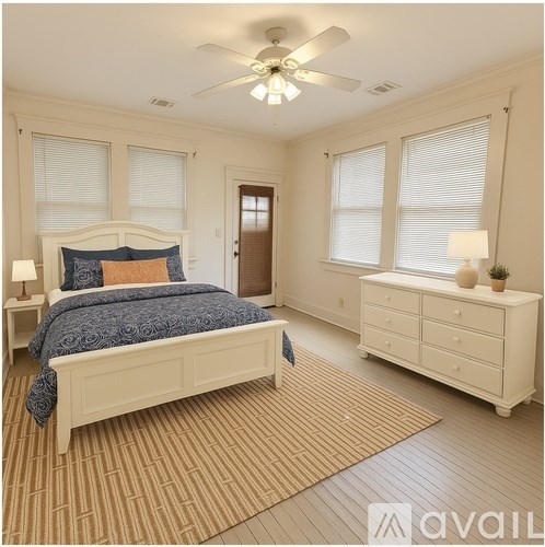 A bedroom with a bed, dresser, and window blinds.