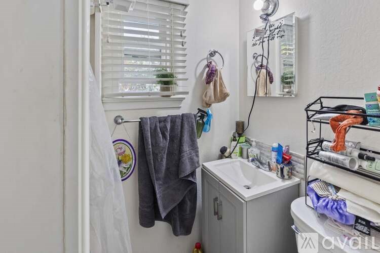 A bathroom with a towel hanging on the towel rack.