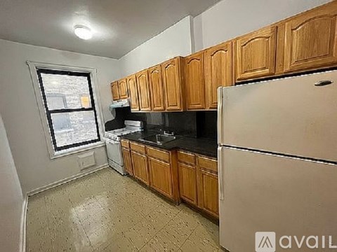A kitchen with wooden cabinets and a white refrigerator.