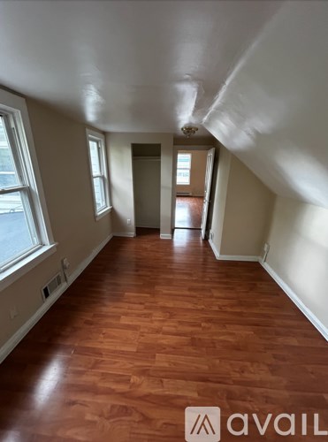 A room with wooden floors and white walls.