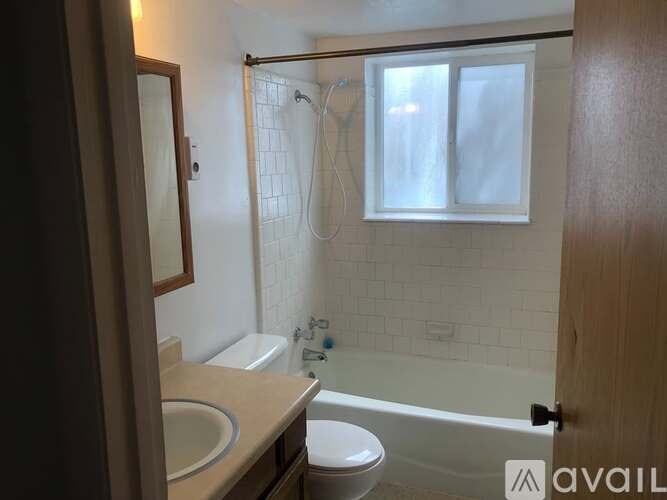 A bathroom with a toilet, sink, and bathtub.