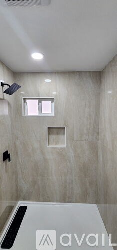 A bathroom with a large mirror and a window.