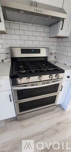 A modern kitchen with a stove top oven.