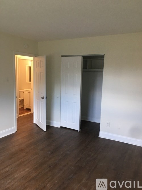 A room with a white door and a white wall.