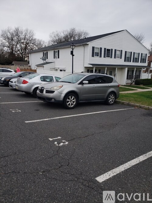 A silver car is parked in a parking lot.