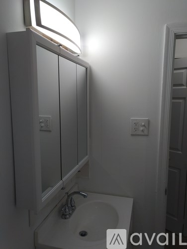 A bathroom with a sink and a mirror.