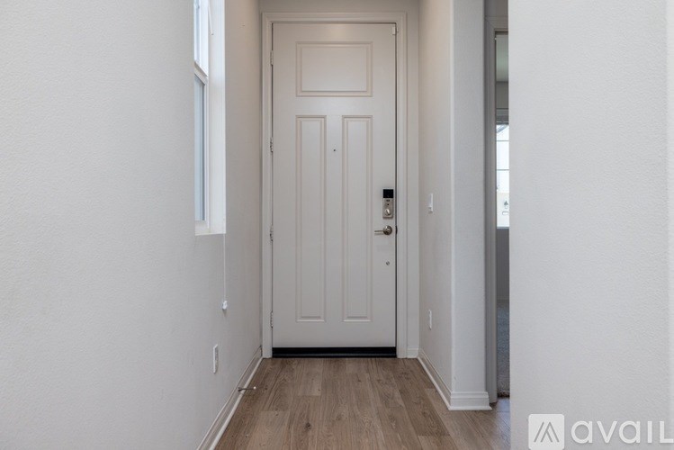 A white door is in the middle of a hallway.