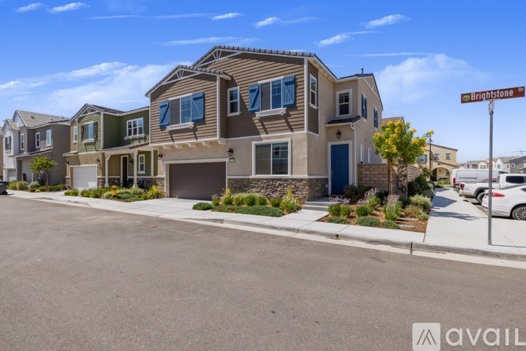 A row of houses with a street sign that says Brightstone.