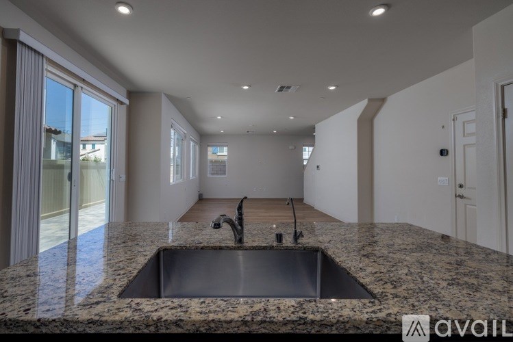 A kitchen with granite countertops and a sink.