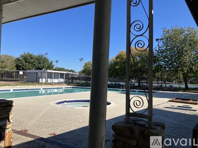 A swimming pool with a metal pole in the foreground.