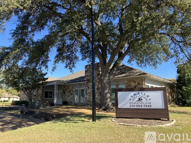 A sign for a recreation club is in front of a house.