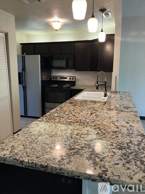 A kitchen with granite countertops and a sink.