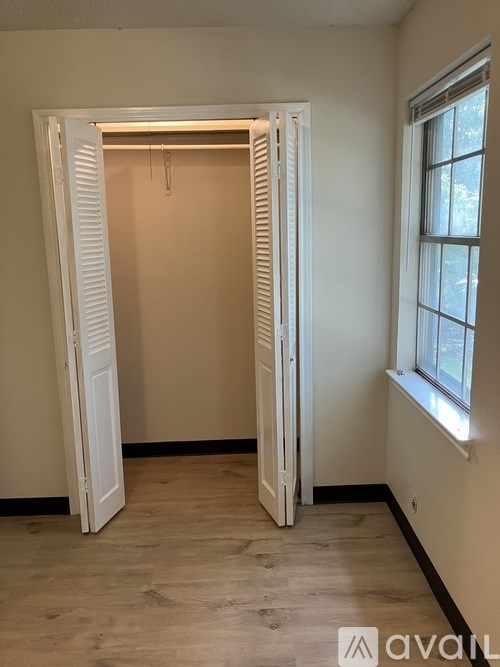 A room with a window and a door.