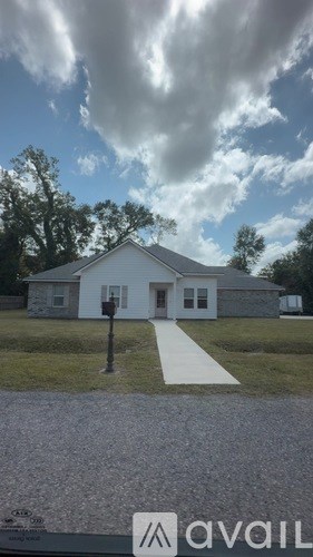 A house with a driveway in front of it.