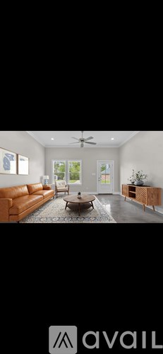 A living room with a brown leather couch and a coffee table.