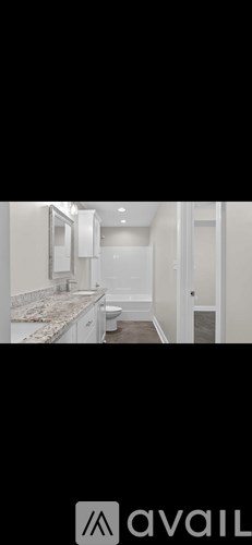 A bathroom with a marble countertop and a toilet.
