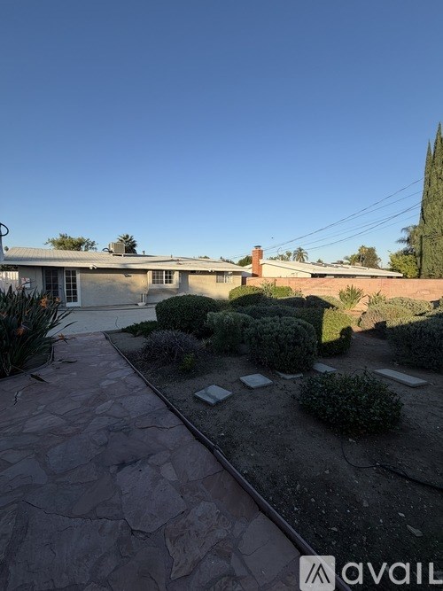 A house with a stone pathway leading to the front door.