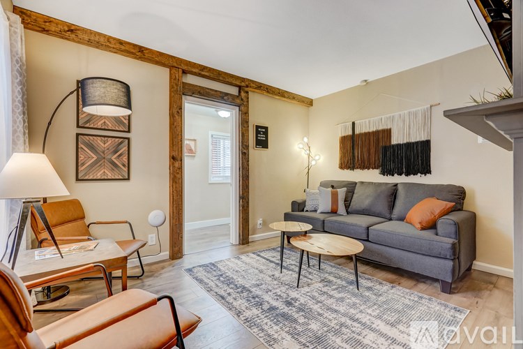 A living room with a grey couch and a wooden coffee table.