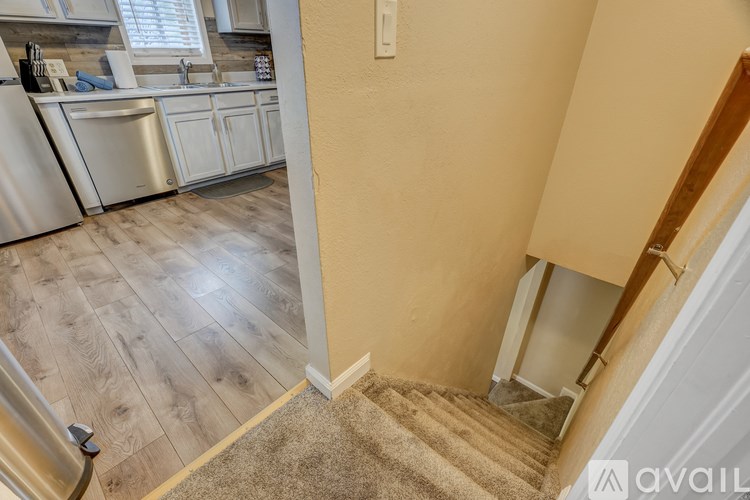 A kitchen with a stainless steel refrigerator and a sink.