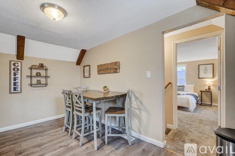 A dining area with a wooden table and chairs.