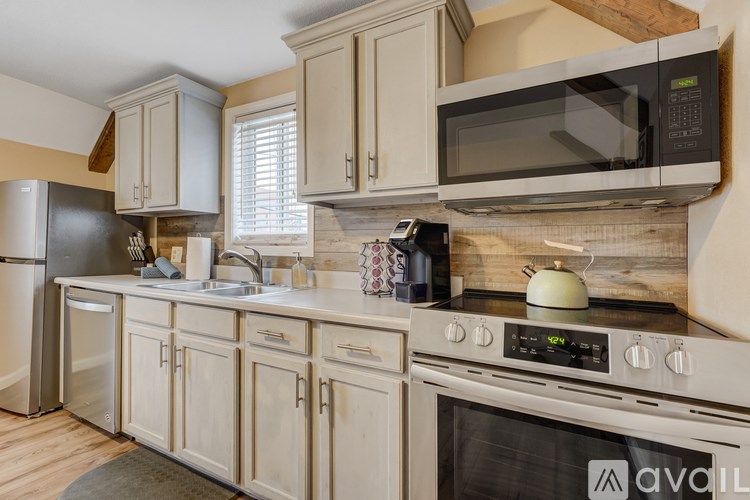 A kitchen with a stove, oven, and microwave.