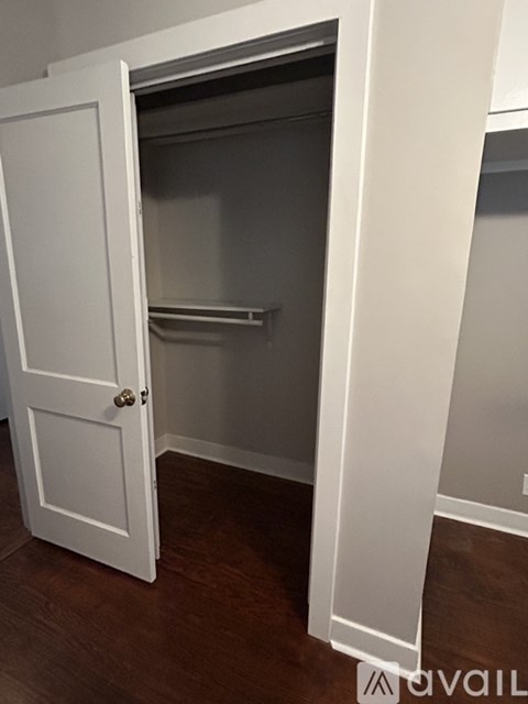 A white door is open to a small pantry.
