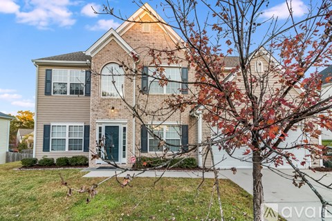 A house with a tree in front of it.