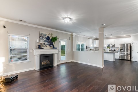 A spacious living room with a fireplace and hardwood floors.