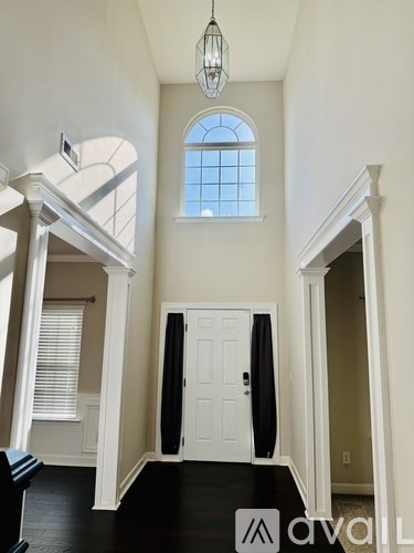 A white door is in the middle of a hallway.