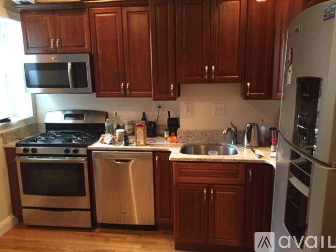 A kitchen with wooden cabinets and stainless steel appliances.