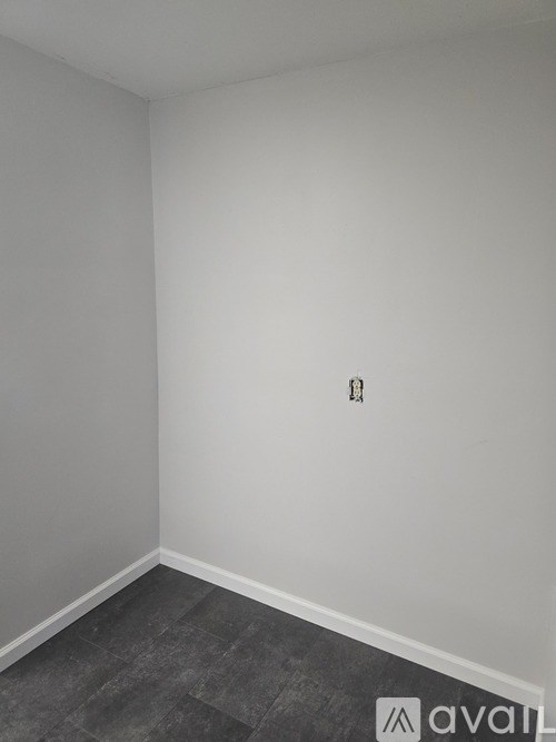 A room with a grey floor and white walls.