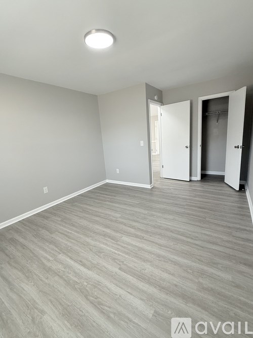 A room with a grey floor and white walls.