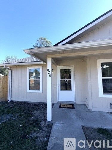 A house with a white door and a window is for sale.