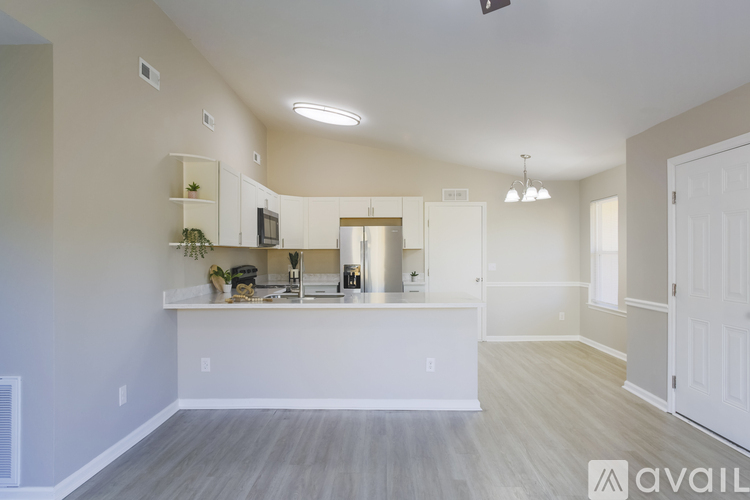 A modern kitchen with white cabinets and a large island.