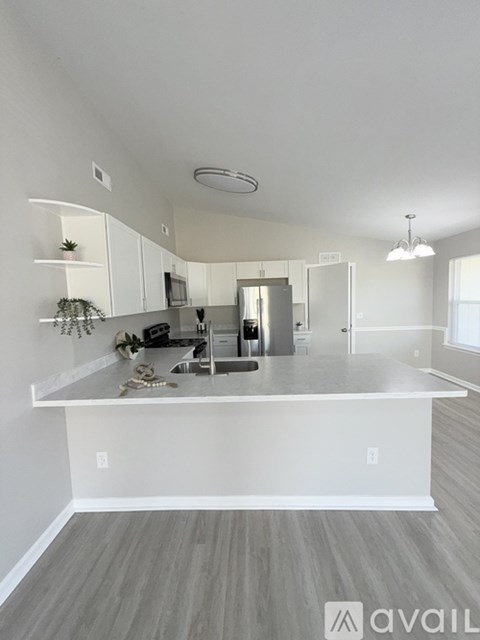 A modern kitchen with white cabinets and a large island.